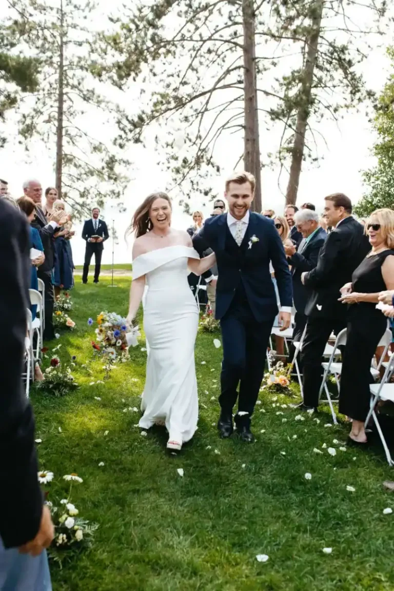 Bride and groom walking down wedding aisle happily after saying vows during an outdoor wedding in Northern Wisconsin at Chippewa Retreat