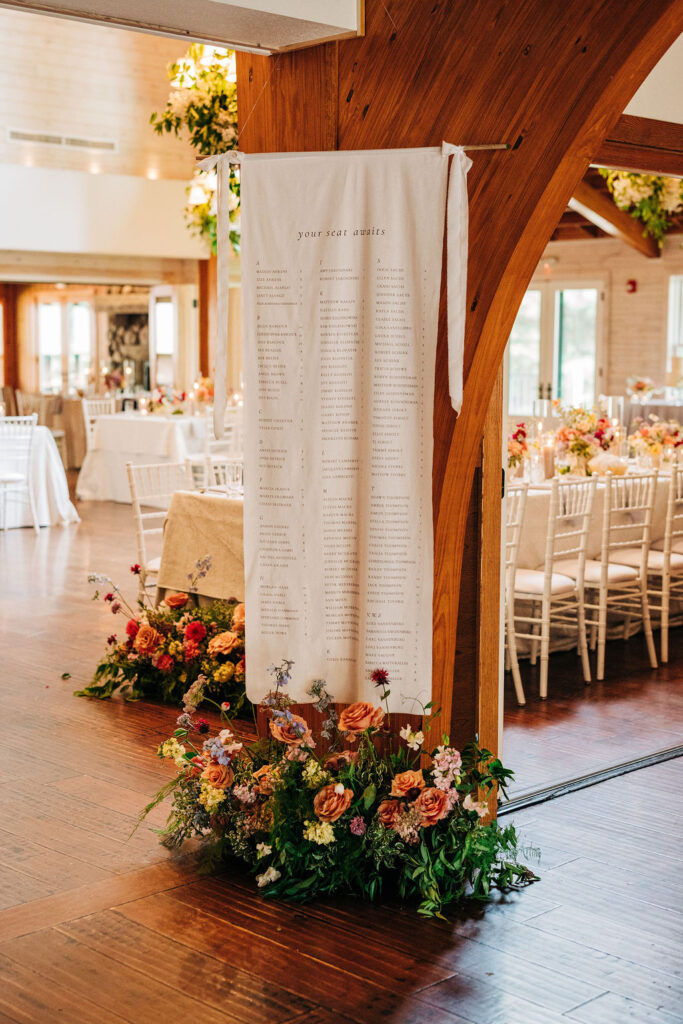 Seating Chart by Lettered by Shi hung as guests enter the main dining room — Katie Ricard Photography
